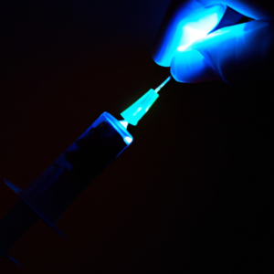 A close-up of a human hand being injected with a syringe, with a blue light emanating from the tip.