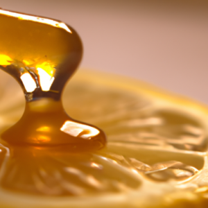 A close-up of a lemon slice with a drop of honey on its surface.