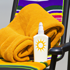A beach chair with a bottle of sunscreen and a beach towel draped over it.