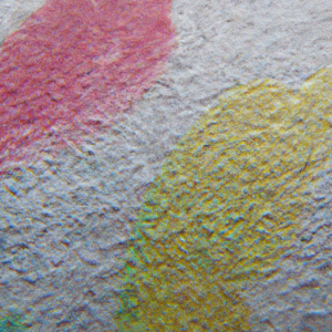  A close-up of a multicolored surface with various shapes, textures, and patterns.