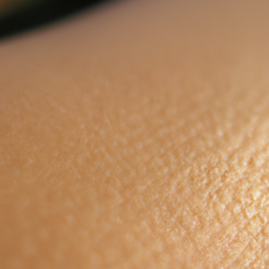 A close-up of a sun-drenched skin with small dark spots visible.
